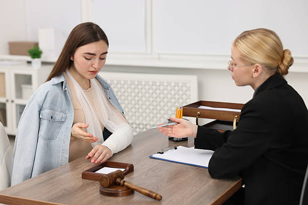 Client and advocate discussing a vehicle wreck case across a desk